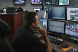 Man in front of security monitors