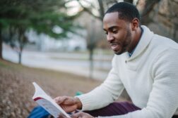 Young professional reads outdoors