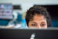 Woman looks at computer