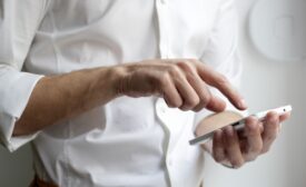 Person holds white cellphone