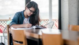 university student studies at desk