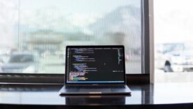 laptop on desk by window