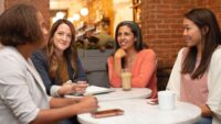 business women sit at table