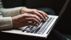 typing hands on computer keyboard