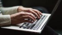 typing hands on computer keyboard