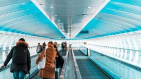 passengers moving through airport terminal