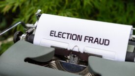 typewriter with paper saying election fraud