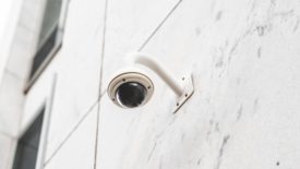 surveillance camera on white building