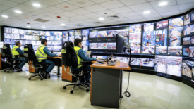 security officers watching video monitor