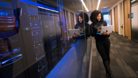 Woman with Laptop in Server Room