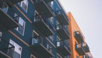 side of blue and yellow apartment building