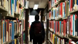 student walking through library