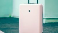 pink suitcase on ground