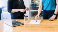 Two people meeting over notebook