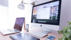 monitor, laptop and phone on desk