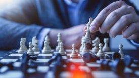 person playing chess in suit