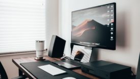 computer desk with keyboard and speaker