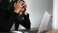 Woman frustrated at laptop