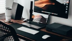 desk with two monitors and speaker