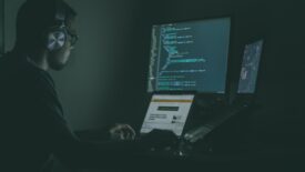 person working at a computer with headphones