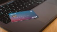 blue and pink credit card on laptop