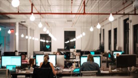 people working at long desk together