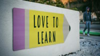 School sign with pencil that says love to learn