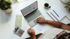 Person with laptop and calculator