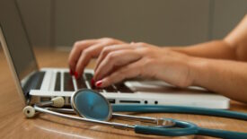 Person using laptop in hospital