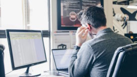 Person working at desk with big monitor