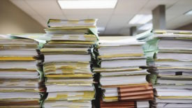 Files stacked onto desk