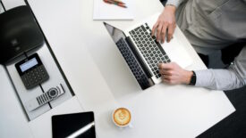 Person working at desk with coffee