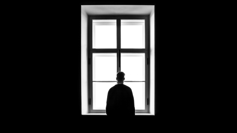 Man standing in front of window