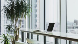 White desk with laptop in front of windows