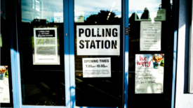 Polling station sign in glass door