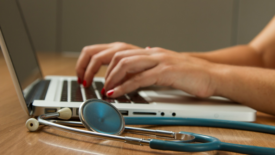 Woman with laptop and stethoscope