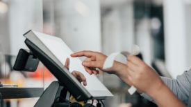 Cashier collecting receipt from printer