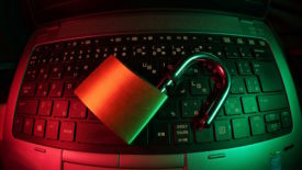 Padlock open on keyboard with red and green lights