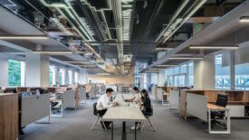 People sitting at table in shared office space