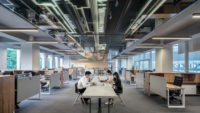 People sitting at table in shared office space