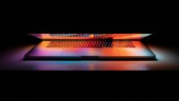 Half open laptop with multicolored lighting