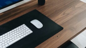 Wooden desk with white keyboard and mouse