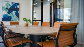 board room table with brown chairs and large windows