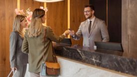 Guests checking in at hotel front desk