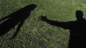 Shadow of a man reaching for a woman