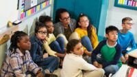 Children huddled in the corner of a classroom