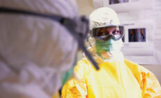 Here, a CDC healthcare worker takes the proper measurements to ensure that she is protected in an Ebola clinic in West Africa - Security Magazine